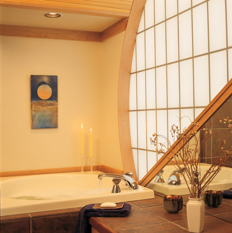 
Flanked by a half-moon Kal-Wall window, the deep tub in the bathroom is a serene spot for relaxation. “I can’t tell you how much I like that spot,” Susanka says. “It’s so far beyond what I ever thought a bathroom could be. I really love the feeling—it’s almost like being in a cocoon.”
